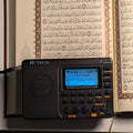 TDBR Qur'ān Radio displaying a repeated Surah Yusuf ayah for memorisation in front of an open Mushaf, Hifdh Pack
