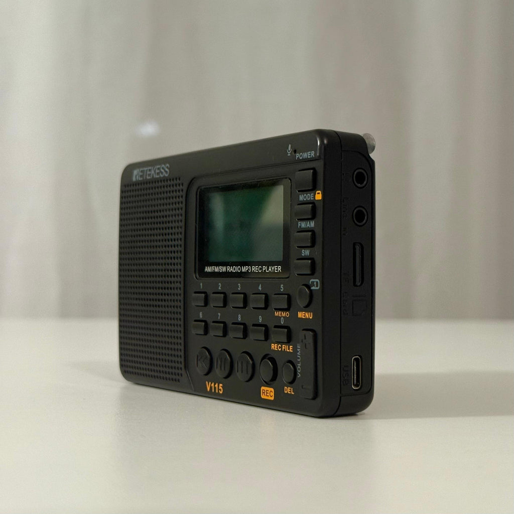 The Qur'ān Radio+ from the side, showing the screen, number keypad, volume control and charging port