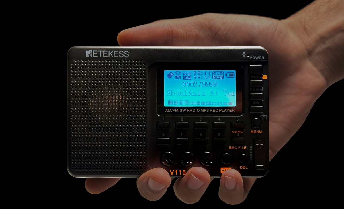 A hand operating the TDBR radio’s physical controls
